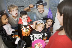 Six children in costumes trick or treating